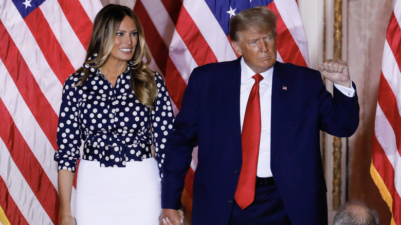 Melania Trump holding hands with Donald Trump