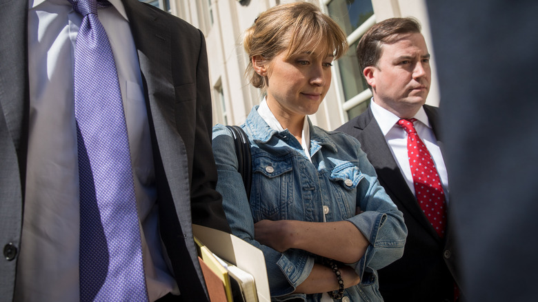 Allison Mack and her team exiting court in 2018