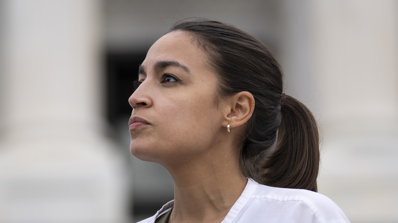 AOC looking to her right 