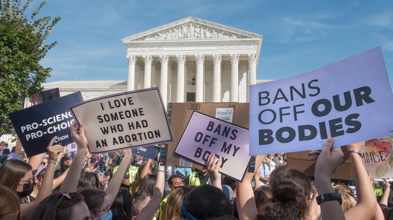 pro-abortion protestors holding signs and marching