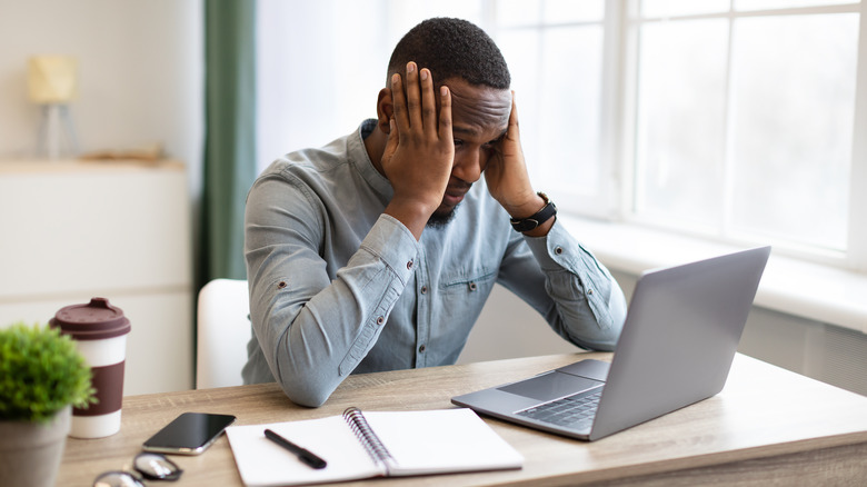 man burnt out at desk 