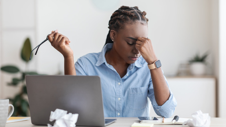 overworked woman at desk 