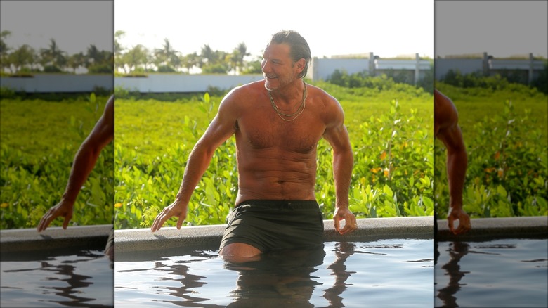 Ty Pennington sitting by a pool