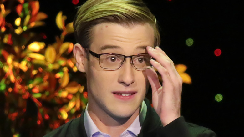 Tyler Henry adjusting glasses