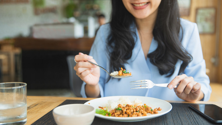 Woman eating brown rice 