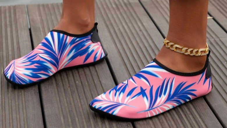 A pair of yellow flip flops on blue background