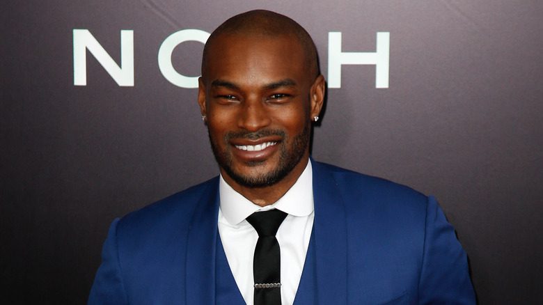 Tyson Beckford wears a blue suit