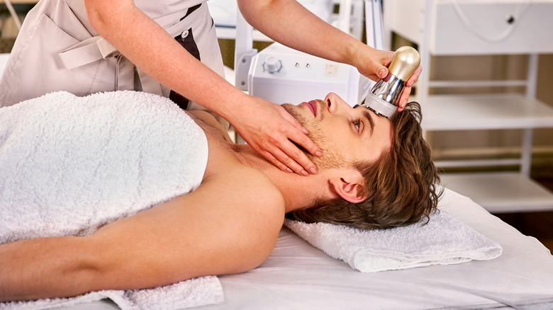 man getting ultherapy at a cosmetic surgery office