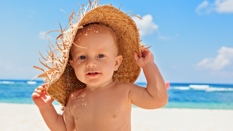 Baby wearing a straw hat