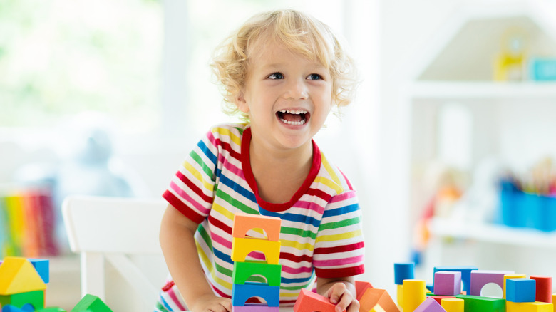 Blonde toddler playing with blocks