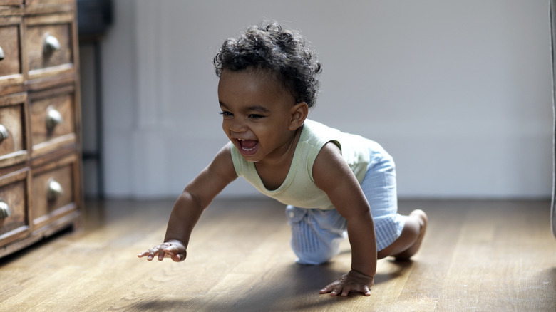 Baby crawling and smiling