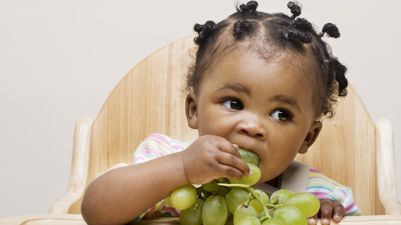 Baby eating grapes