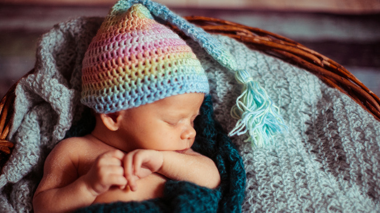 Baby wearing a rainbow cap