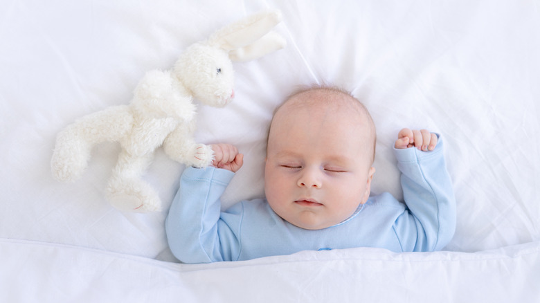 Baby sleeping with stuffed animal