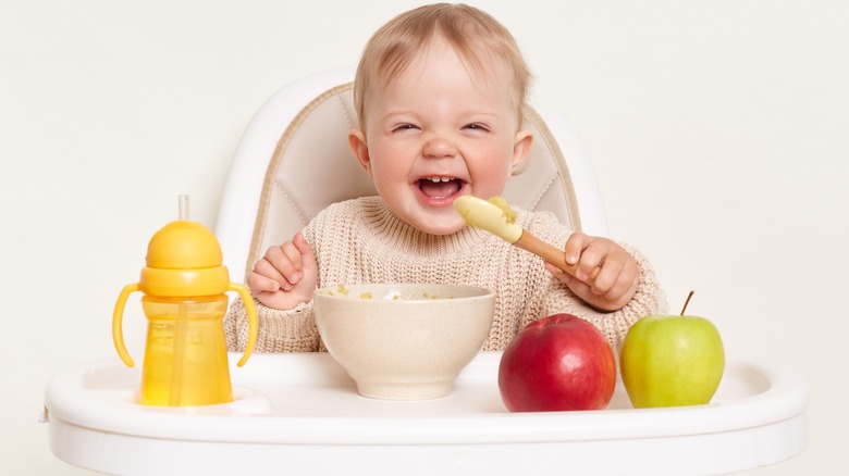 Baby eating in high chair