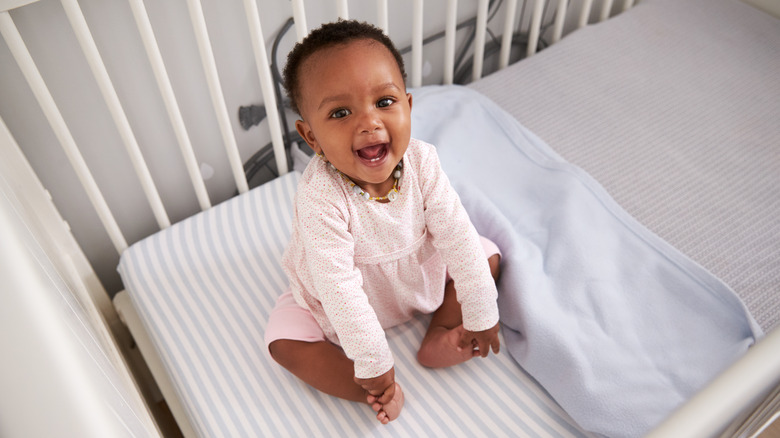 Baby smiling in crib