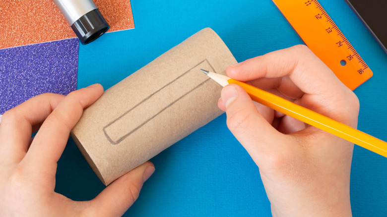 hands with paper roll