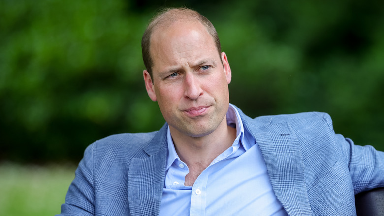 Prince William sitting on a bench