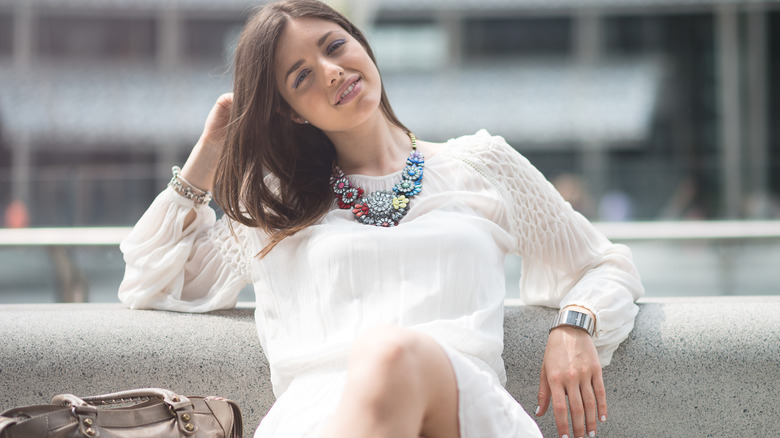 woman sitting on bench in dress