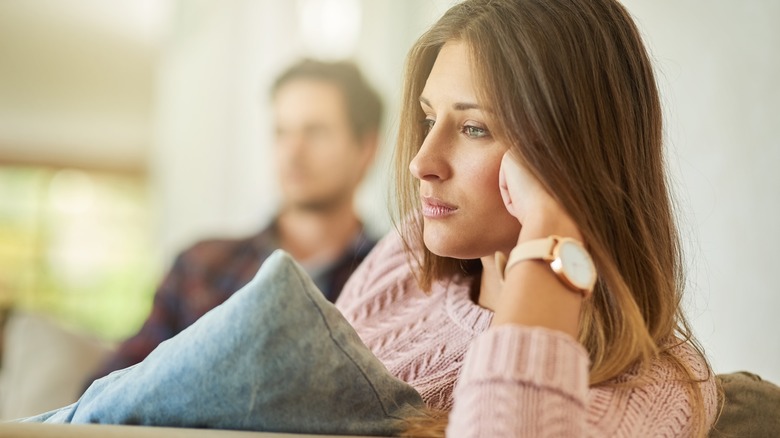 Stressed couple sitting on the couch