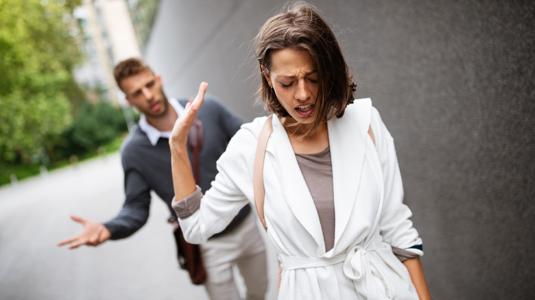 Woman walking away from her partner