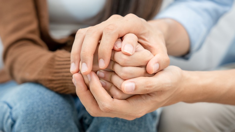 Couple holding hands