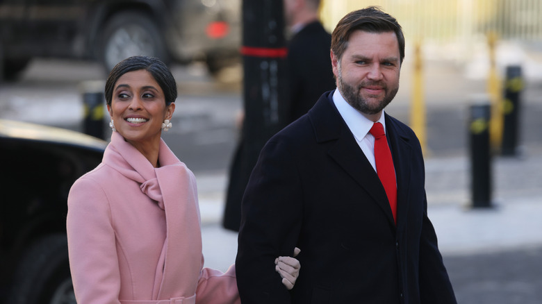 Usha holds JD Vance's arm as they walk