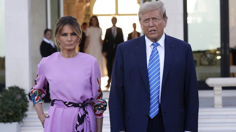 Melania Trump purple jumpsuit with Donald Trump