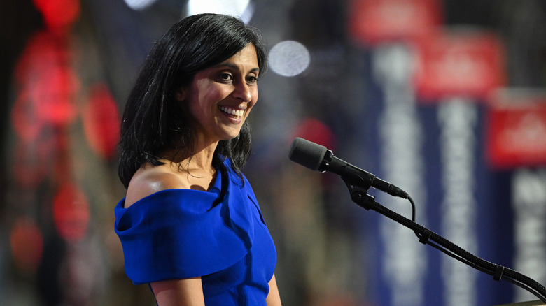 Usha Vance smiling at a microphone in a blue dress