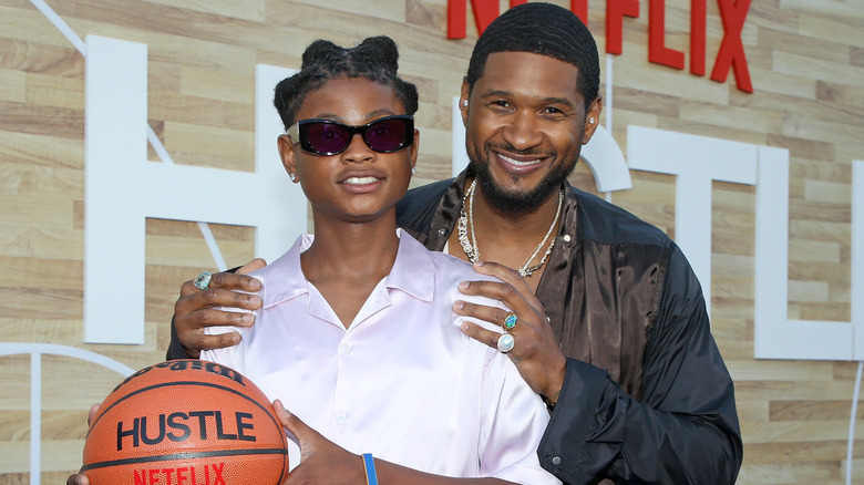 Usher posing with his son, Cinco