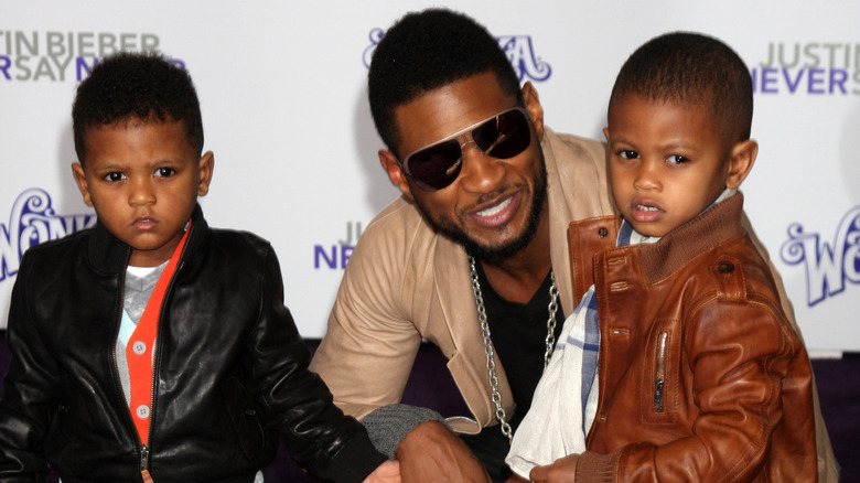 Usher Raymond with his sons