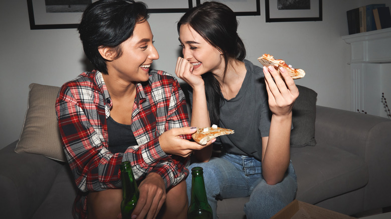 couple laughing eating pizza