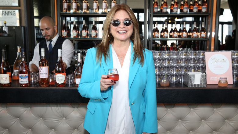 Valerie Bertinelli posing with a glass of wine