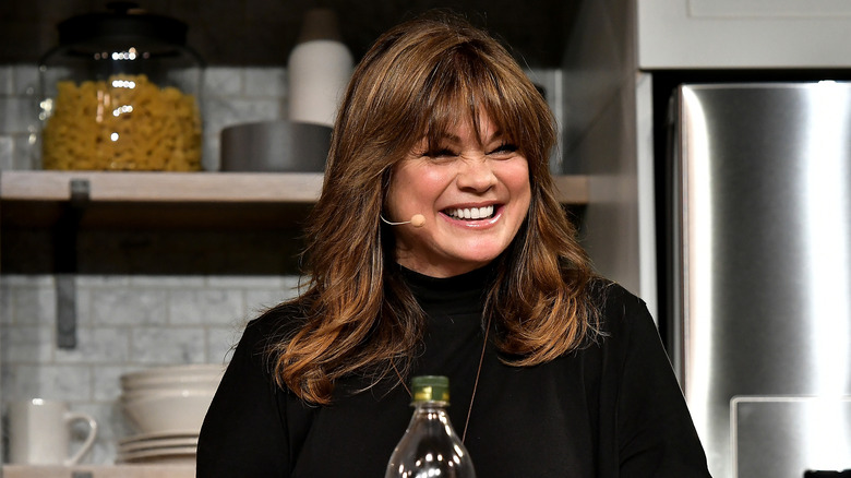 Valerie Bertinelli wearing a microphone and smiling