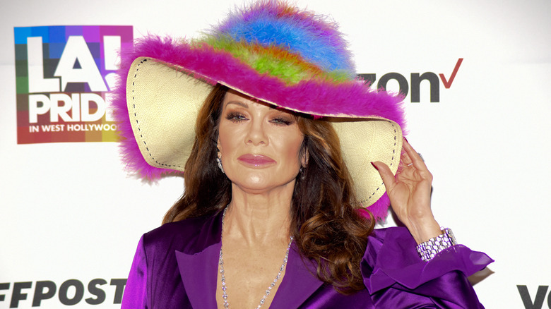 Lisa Vanderpump posing in rainbow, fluffy hat