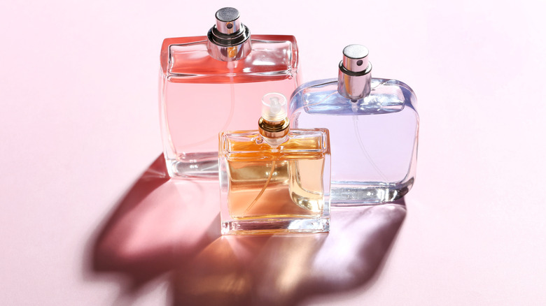 perfume bottles on a pink table