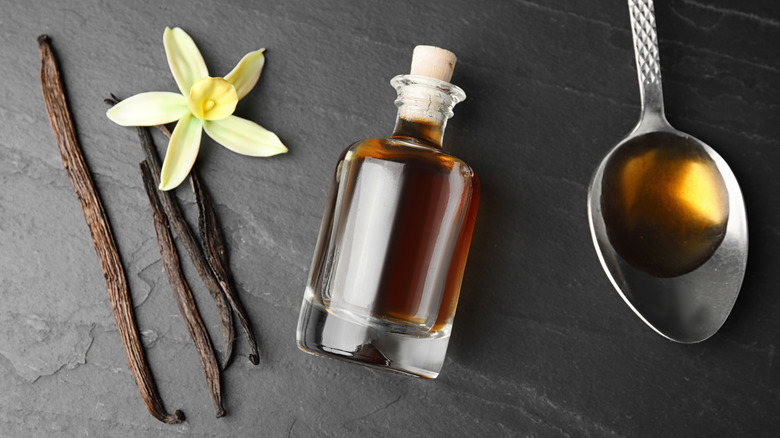 vanilla pods and a bottle on a table