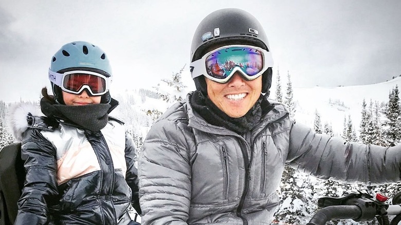 Vern Yip on snowmobile with young daughter