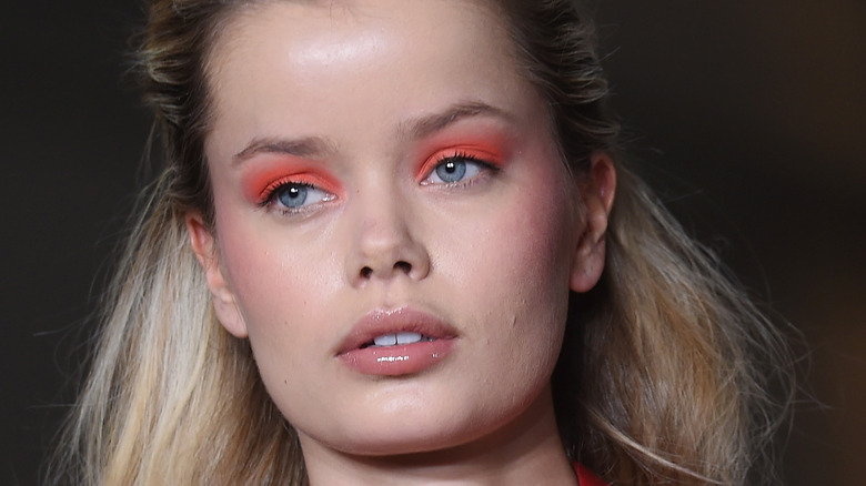 Woman wears orange eyeshadow for Fashion Week