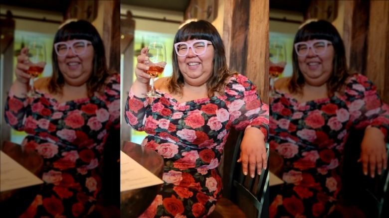 Virgie Tovar smiling and raising glass