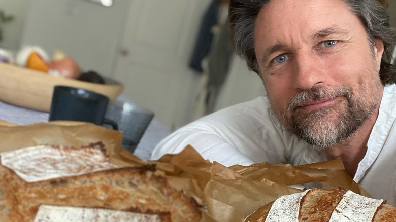 Martin Henderson posing with his sourdough loaves