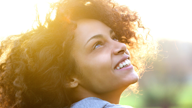 Woman looking up smiling 