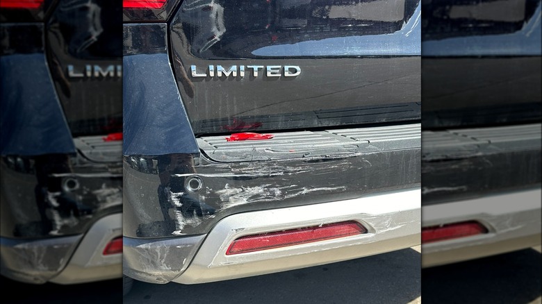 scratches on the back of a black car