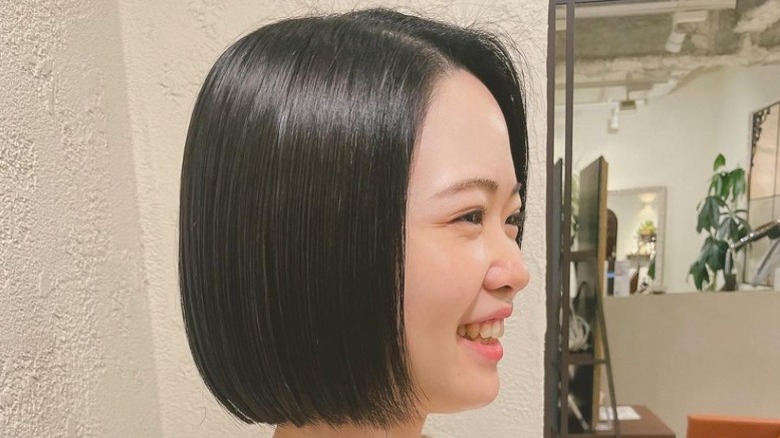 woman with job haircut smiling