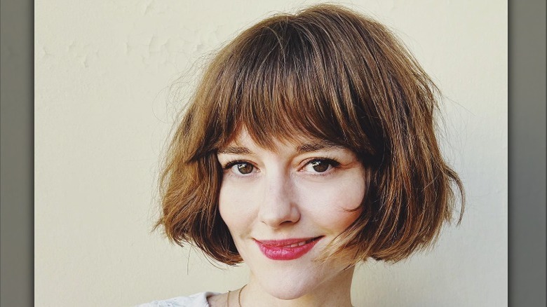 woman with french bob smiling