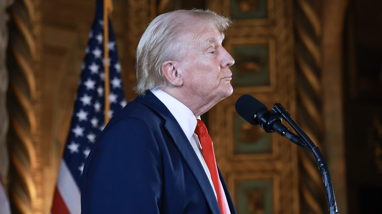 Donald Trump standing in front of microphone