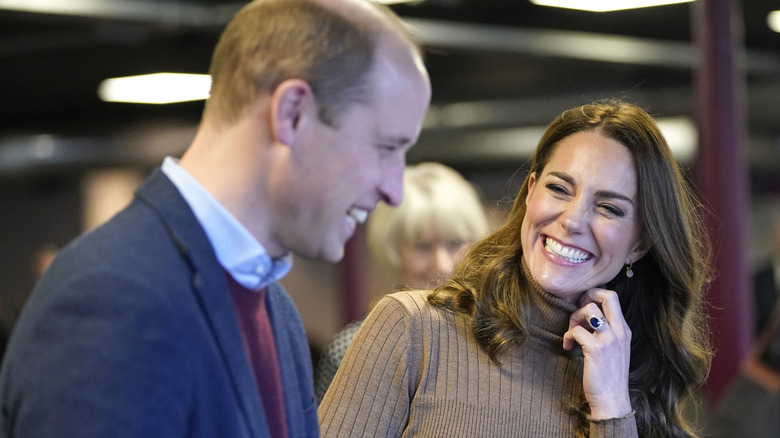 Prince William and Kate Middleton laughing with one another