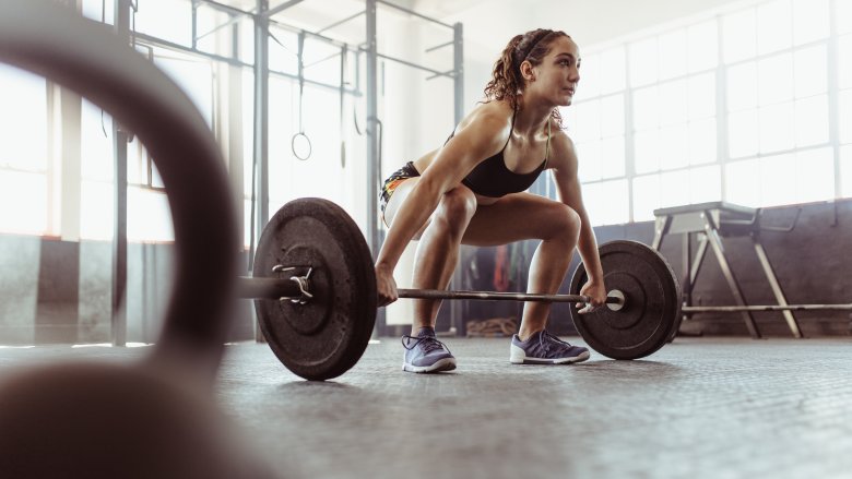 young woman lifting weights