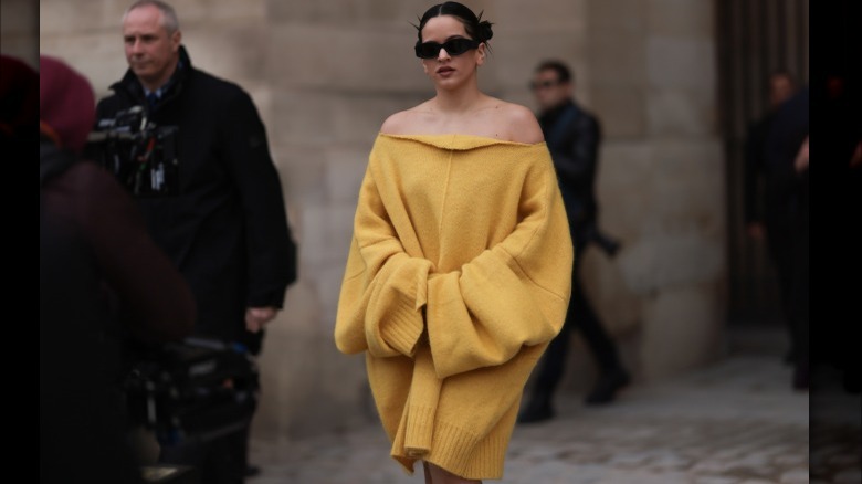 A woman wearing an oversized sweater