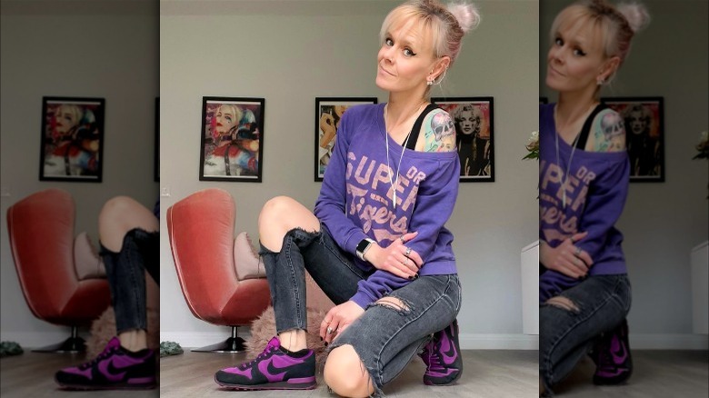 Woman in jeans and purple sweatshirt